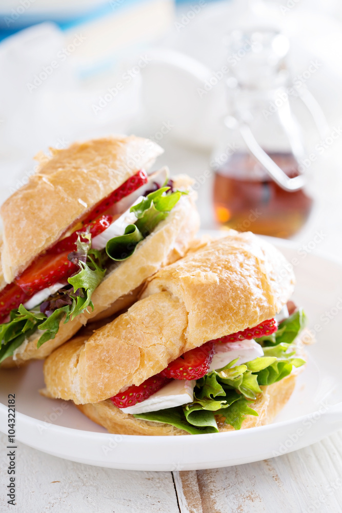 Croissant sandwich with brie, salad and strawberry Croissant sandwich with brie, salad and strawberry