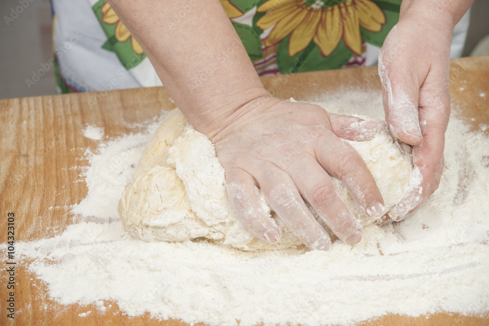 Women's hands prepairing fresh yeast dough Women's hands prepairing fresh yeast dough