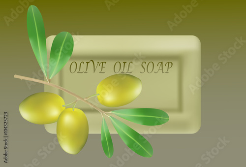 Olive's branch on natural olive oil soap isolated on green background.