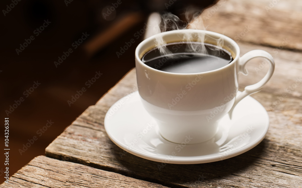 Close-up of coffee cup  on wooden background.