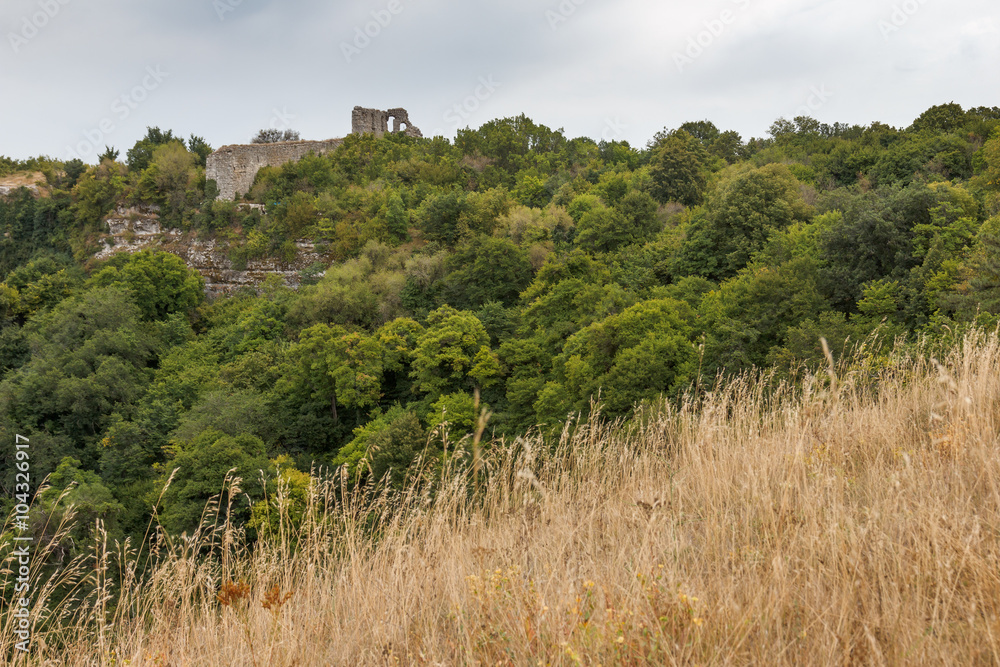 Crimea. Cave city Mangup-Kale in the summer cloudy day. The ruins of the citadel on top of the mountain