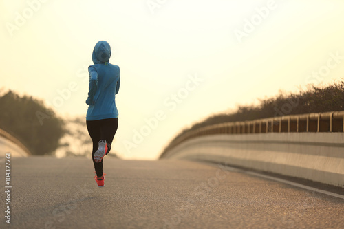 young fitness woman trail runner running  on city road