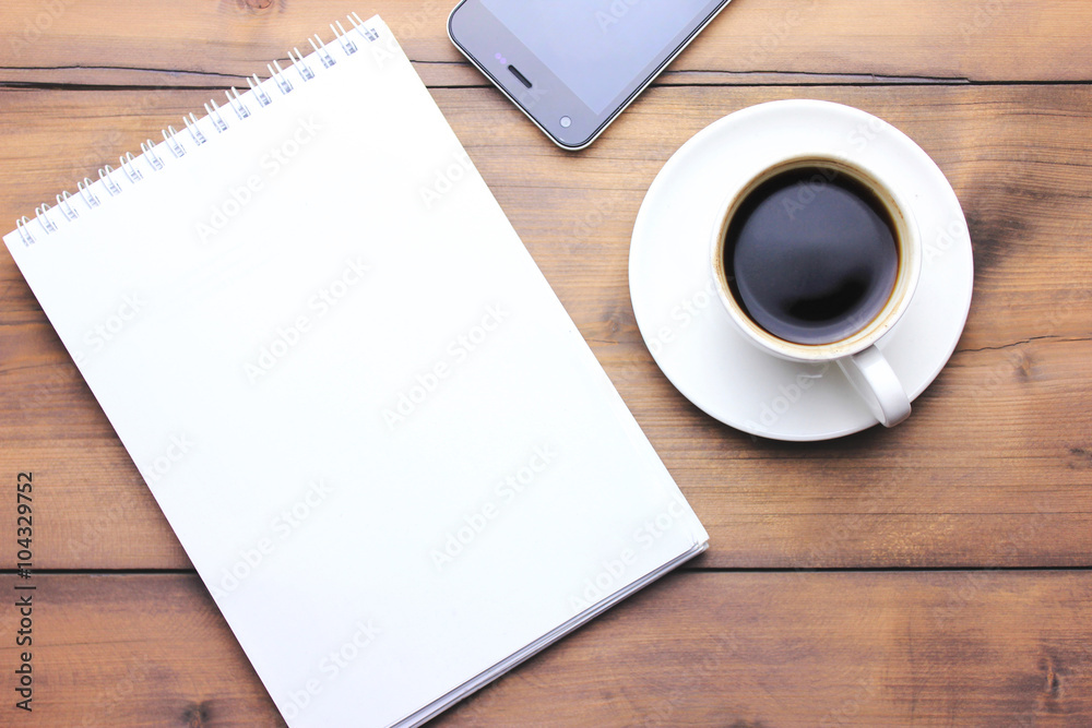 notebook, phone and coffee on table notebook, phone and coffee on table