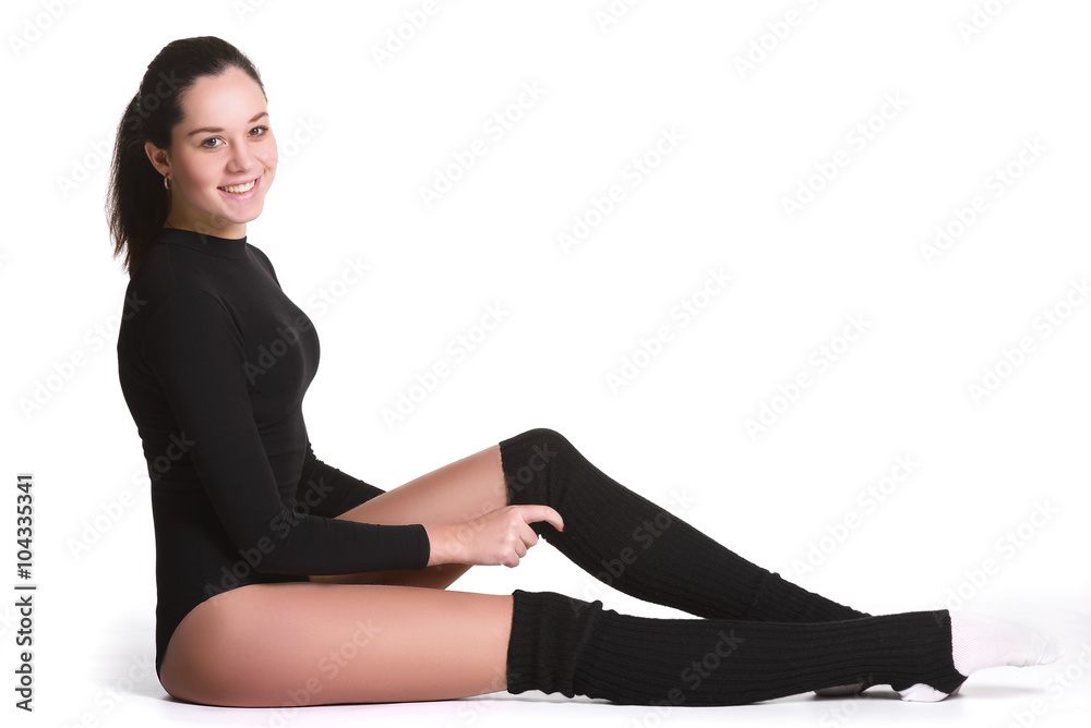 Young cute woman in gymnast suit resting on white background Young cute woman in gymnast suit resting on white background