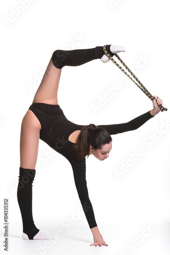 Young cute woman in gymnast suit show athletic skill with gymnastic rope on white background