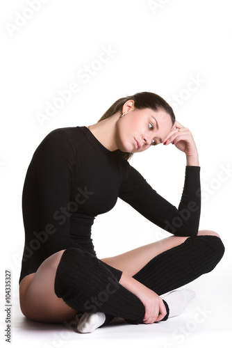 Young cute woman in gymnast suit resting on white background