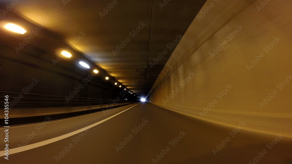 Driver POV through a single lane tunnel into sunshine. Driver POV through a single lane tunnel into sunshine.