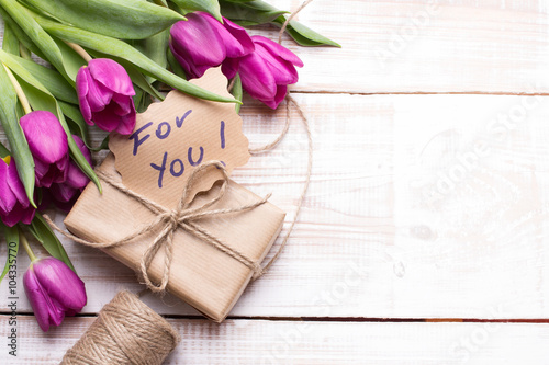 words FOR YOU and bouquet of tulips on wooden background