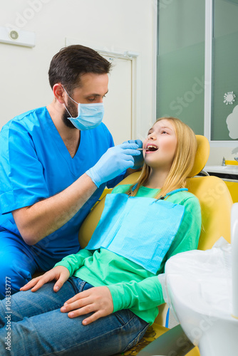 Little girl sitting in the dentists office