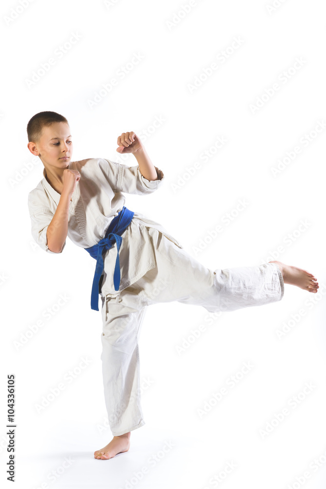 boy in kimono during training karate exercises on white background boy in kimono during training karate exercises on white background