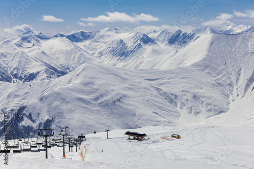 Panoramic view on ski station on snowy mountains background