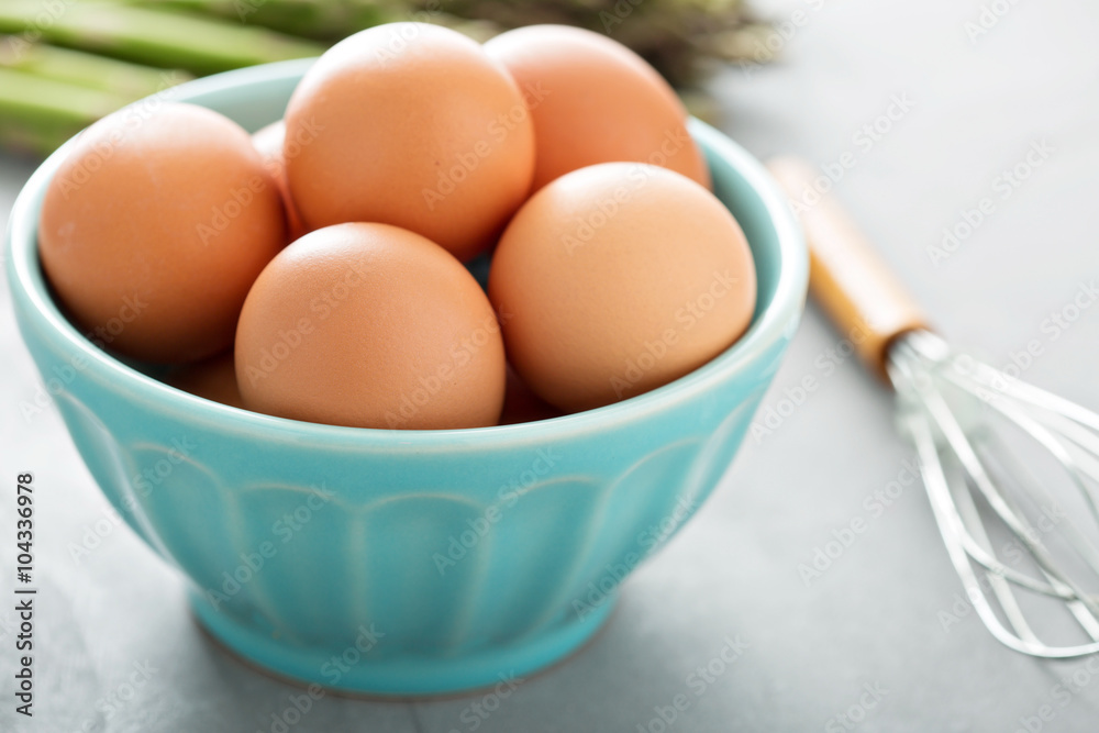 Fresh eggs in a bowl with whisk Fresh eggs in a bowl with whisk