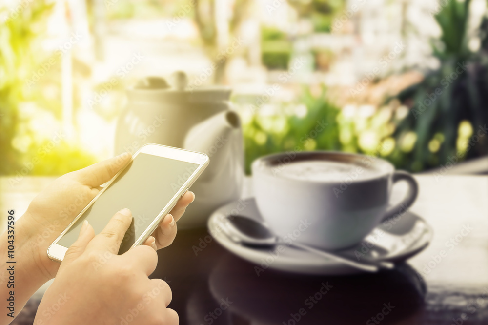 The women using smart phone on coffee shop