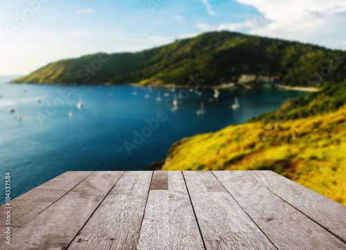 Wood floor top on blurred blue sea and island view point