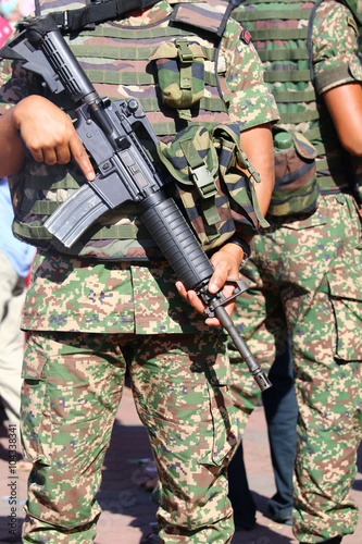 Military personnel with assault rifle