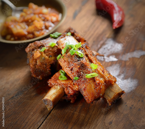 fried pork ribs on a wooden background