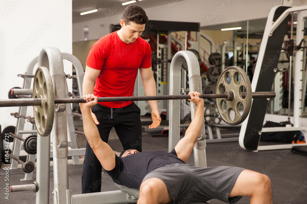 Man spotting his friend on a bench press Man spotting his friend on a bench press