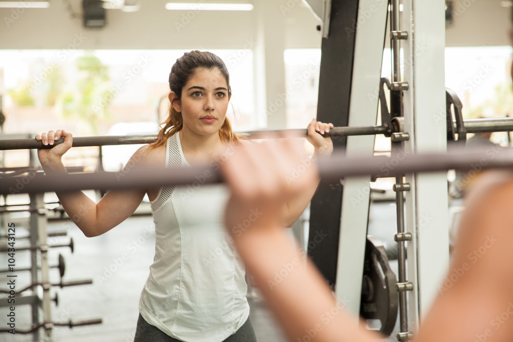 Beautiful girl on a squat machine at the gym Beautiful girl on a squat machine at the gym