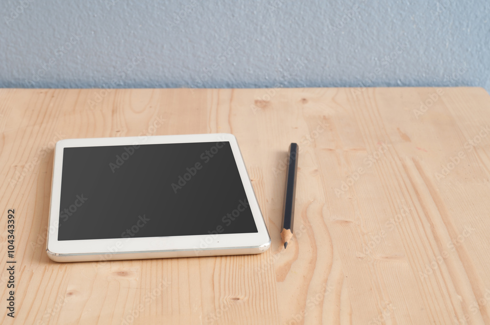 Office desk with Tablet and Pencil on wood floors. Office desk with Tablet and Pencil on wood floors.