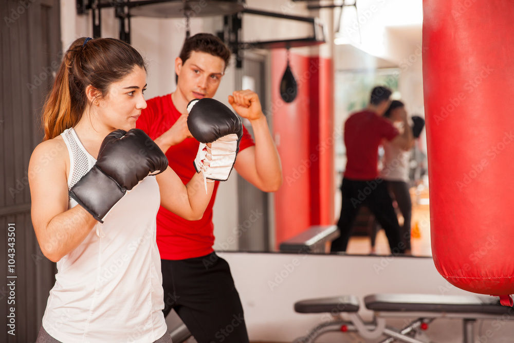 Attractive brunette boxing at the gym