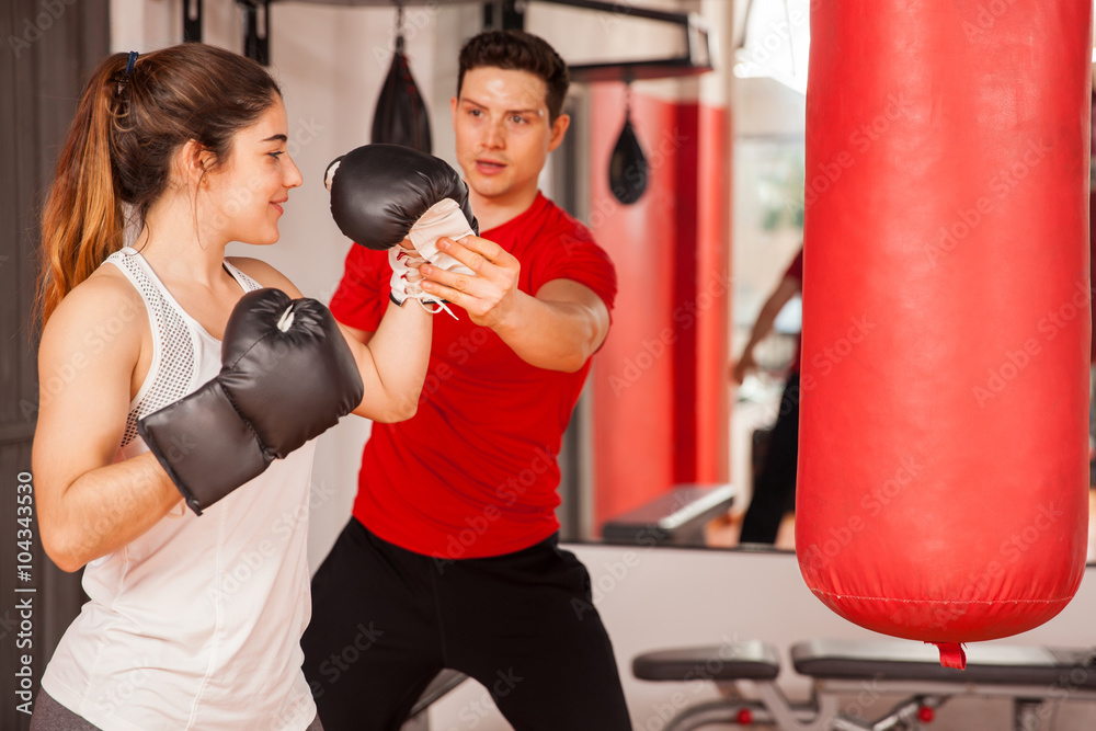 Strong woman getting boxing lessons