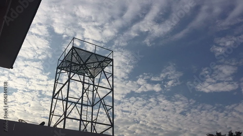 timelapse sky and clouds with scaffold in the foreground
