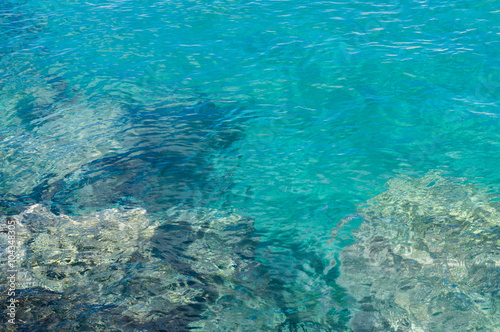Transparent turquoise water near rocky coast