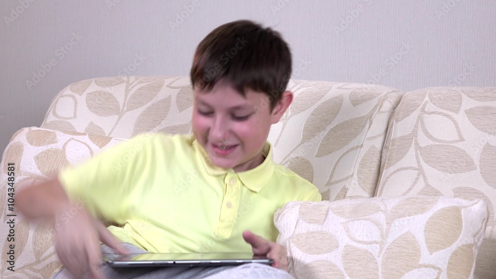 Smiling little boy with tablet pc computer at home Smiling little boy with tablet pc computer at home