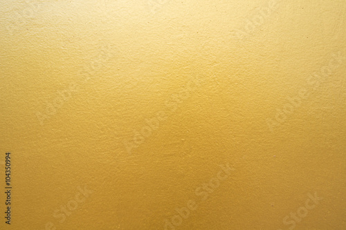 Gold concrete wall on background texture.