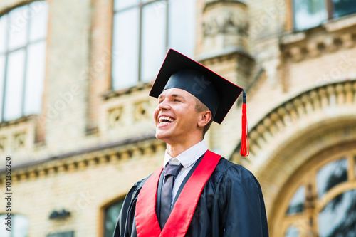 Portrait of a happy graduate male student - graduation concepts