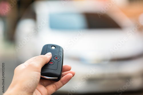 Female hand open the white car on key system automatic.