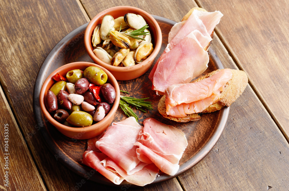 Tapas of salmon, mussels, jamon and olives