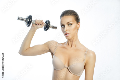 Slim woman with a dumbbell