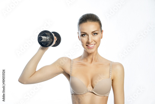 Beautiful slim woman with a dumbbell