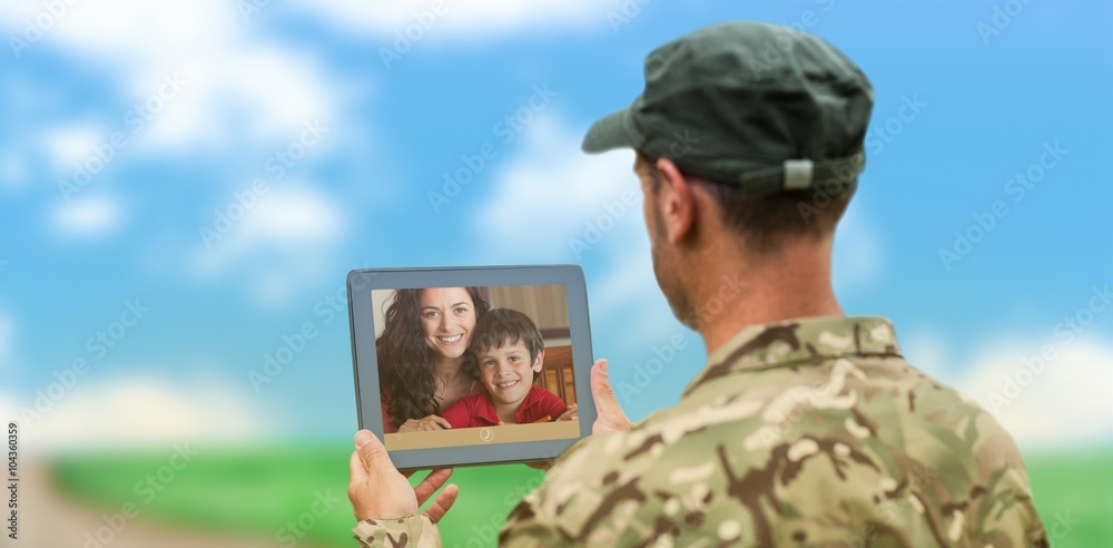 Composite image of soldier using tablet pc