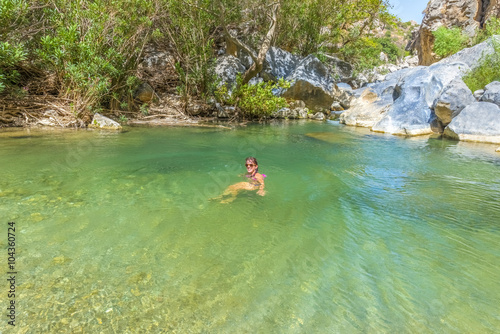 Young pretty girl enjoying the sea at the magnificent Preveli be