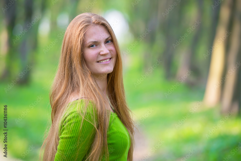 Pretty woman with red hair in the park Pretty woman with red hair in the park