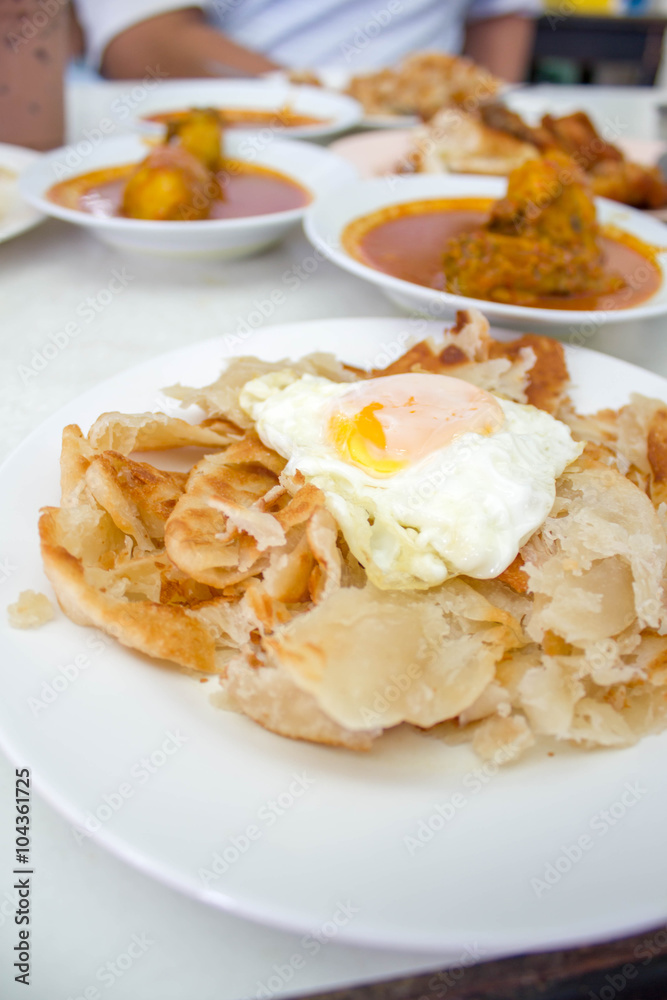 Roti canai with egg and curry