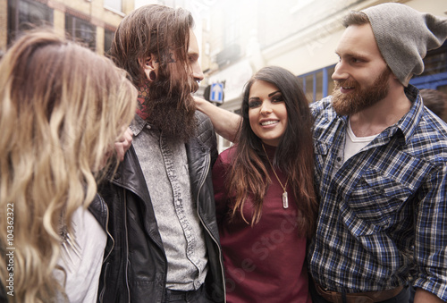 Group of friends standing on the street © gpointstudio