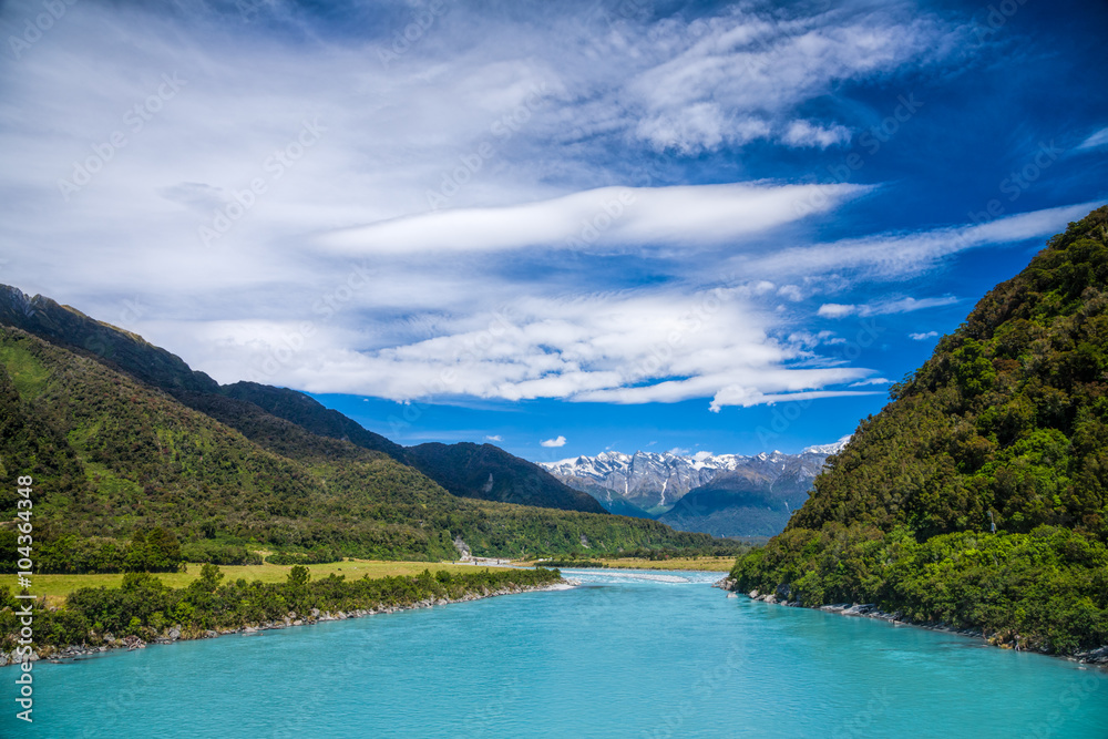 Milky blue glacial water of Whataroa River in New Zealand