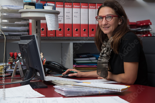 woman in the office working on documents and computer