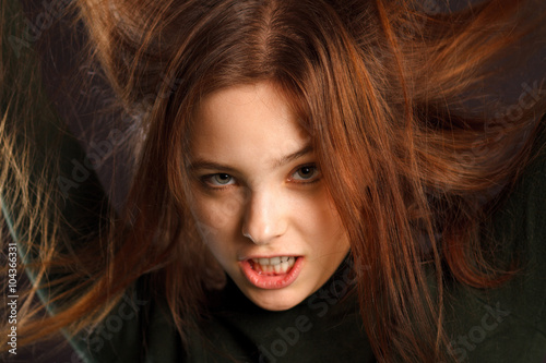 Portrait of redhead woman on dark