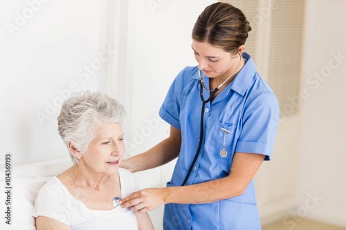 Doctor taking care of suffering senior patient 
