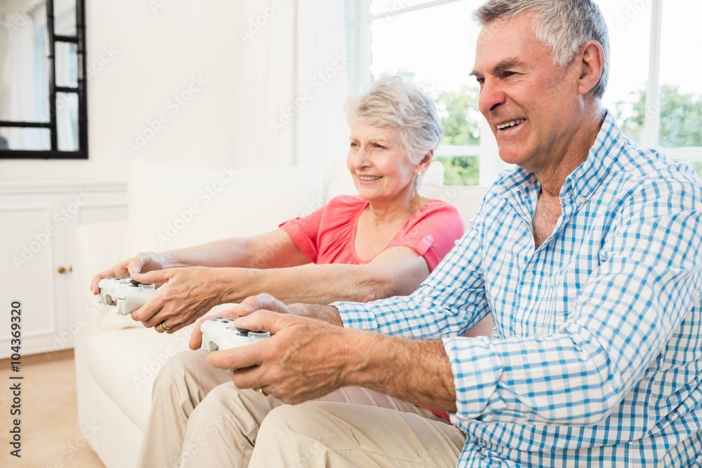 Happy senior couple playing video games Happy senior couple playing video games