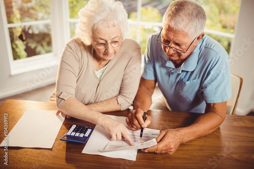 Senior couple counting bills photo