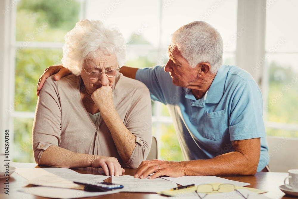 Senior couple counting bills Senior couple counting bills