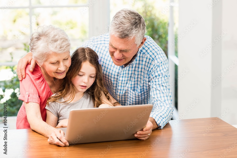 Grandparents and granddaughter using laptop Grandparents and granddaughter using laptop