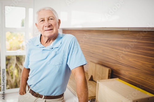 Senior man standing and looking at the camera