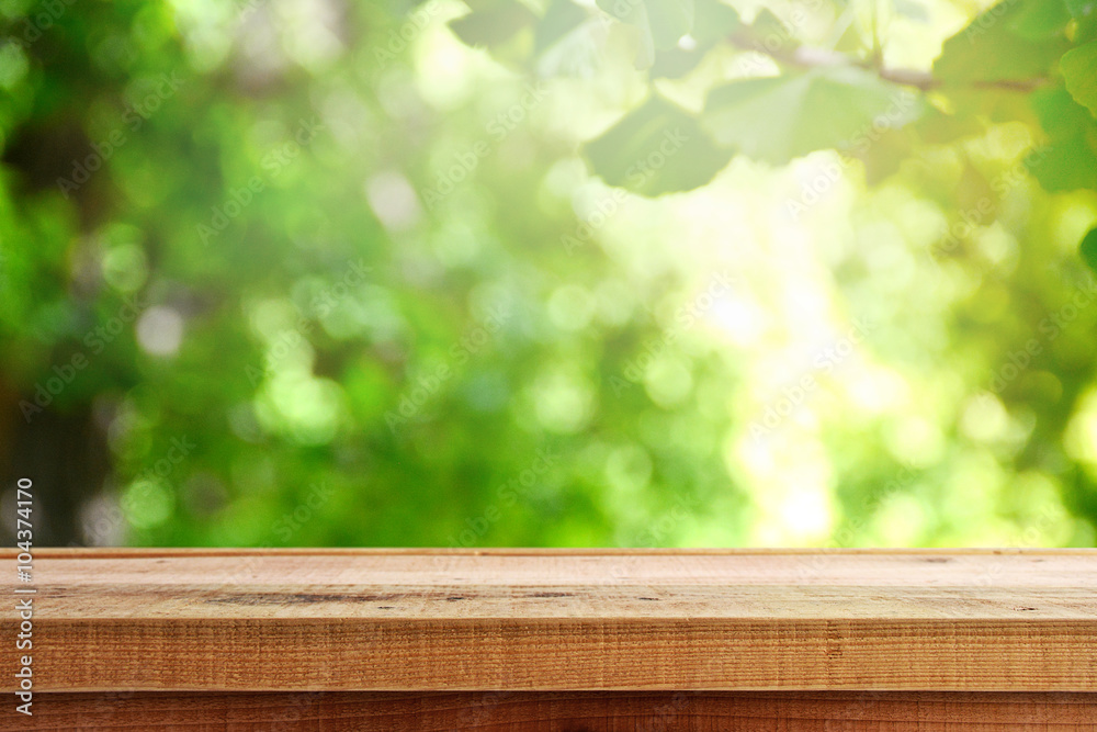 Wooden desk and blur green forest background. Wooden desk and blur green forest background.