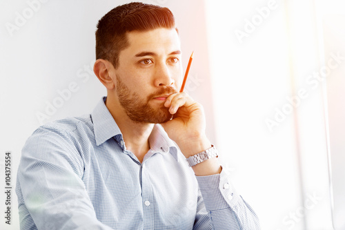 Attractive office worker sitting at desk
